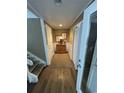 Bright hallway with a wooden cabinet and coastal decor, leading to various rooms with white paneled doors at 701 Norris Dr., Pawleys Island, SC 29585