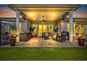 Inviting covered patio with comfortable seating, outdoor decor, ceiling fan, and lush backyard views at 7584 Regina Ct., Myrtle Beach, SC 29572