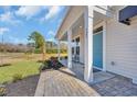 Charming front porch with brick pavers and a bench, perfect for relaxing and enjoying the outdoors at 123 Tbd Joyce Dr, Longs, SC 29568