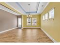 Spacious dining room features gleaming floors, neutral paint, and a modern chandelier at 141 Southgate Ct., Pawleys Island, SC 29585