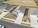 An aerial shot of a light blue home with a manicured lawn and a long driveway in a neighborhood at 1616 Cosmos Lane, Myrtle Beach, SC 29577