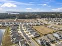 An aerial shot of a well-planned neighborhood with modern homes, green spaces, and a pond at 1616 Cosmos Lane, Myrtle Beach, SC 29577
