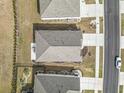 An overhead view of a home with a well-maintained roof, landscaping, and a concrete driveway at 1616 Cosmos Lane, Myrtle Beach, SC 29577