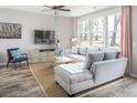 Cozy living room featuring comfortable sofa, stylish decor, and plenty of natural sunlight at 1870 Seachase Way, North Myrtle Beach, SC 29582