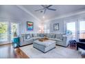 Comfortable living room with a large sectional sofa, hardwood floors, and access to an outdoor balcony at 2425 South Bay St., Georgetown, SC 29440