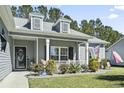 Inviting home exterior with a cozy front porch and manicured landscaping at 334 Marino Trail, Longs, SC 29568