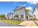 Beautifully landscaped two-story home with coastal design, a well-maintained lawn, and a paved driveway at 382 Lumbee Circle, Pawleys Island, SC 29585