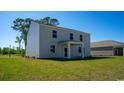 Rear exterior featuring a covered porch overlooking a well-maintained lawn at 4484 East Coast Ln., Shallotte, NC 28470