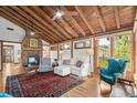 Inviting living room boasts a vaulted wood ceiling, brick fireplace, and bright windows for a warm and cozy atmosphere at 509 14Th Ave. S, North Myrtle Beach, SC 29582