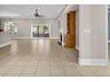 Open-concept living room with tile flooring, fireplace, and access to a patio at 129 Waterfall Circle, Little River, SC 29566
