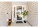 Inviting entryway with decorative sign, a welcome mat, and a stylishly adorned front door at 134 Winding Path Dr., Loris, SC 29569