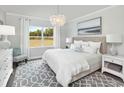 Serene bedroom with a plush bed, elegant lighting, and a view of the outdoors at 2530 Watershed Way, Longs, SC 29568