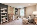 Cozy bedroom with charming decor featuring a crib, patterned wallpaper, and window at 2600 Watershed Way, Longs, SC 29568