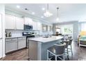 Modern kitchen features a large island, stainless steel appliances, and stylish pendant lighting at 2600 Watershed Way, Longs, SC 29568