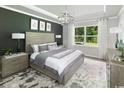 Serene bedroom featuring a king-sized bed, modern decor, and plenty of natural light from the window at 2620 Watershed Way, Longs, SC 29568