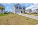 Well-maintained two-story house with light blue siding and a two-car garage at 3304 Candytuft Dr., Conway, SC 29526