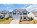 Two-story home with light blue siding and black shutters in a well-kept community at 3304 Candytuft Dr., Conway, SC 29526