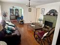 Cozy living room with hardwood floors, a decorative fireplace, and an inviting layout for relaxation at 3328 Rose Hill Rd., Georgetown, SC 29440