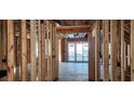 Interior framing showcasing door opening with studs and a view of a patio with sliding glass doors at 37 Winnowing Way, Pawleys Island, SC 29585