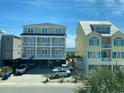 Exterior view of two houses with balconies looking out over the ocean on a sunny day at 4201 N Ocean Blvd. # I3, North Myrtle Beach, SC 29582