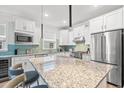 Bright kitchen with white cabinets, stainless appliances, and large granite island at 5834 Cremona Dr., Myrtle Beach, SC 29577