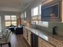 Wet bar area boasts granite countertops, wine fridge, and beverage faucet at 5834 Cremona Dr., Myrtle Beach, SC 29577
