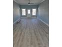 Bright living room with light blue walls, a ceiling fan, and new floors with natural light at 605 15Th Ave. S, North Myrtle Beach, SC 29582