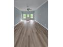 Open-concept living room with wood flooring, recessed lights, and large windows at 605 15Th Ave. S, North Myrtle Beach, SC 29582