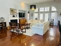 Bright living room boasting hardwood floors, a fireplace, high ceilings, and plenty of natural light at 728 Camden Circle, Pawleys Island, SC 29585