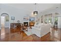 Open living room with fireplace, hardwood floors, and bright, airy atmosphere at 728 Camden Circle, Pawleys Island, SC 29585