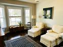 Cozy sitting area featuring plush armchairs, hardwood floors, and large windows for natural light at 728 Camden Circle, Pawleys Island, SC 29585