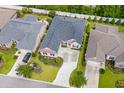 Aerial view of a landscaped home with an asphalt roof, spacious driveway, and lush green lawn at 870 Monterrosa Dr., Myrtle Beach, SC 29572