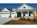 Charming home featuring an attached two-car garage, landscaped yard, and welcoming front porch at 912 Lady Bird Way, North Myrtle Beach, SC 29582