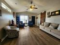 Comfortable living room with hardwood floors, large windows, modern decor, and a sliding barn door at 9883 Conifer Ln., Murrells Inlet, SC 29576