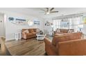 Comfortable living room features wood floors, ample seating, and beach-themed decor for a relaxing atmosphere at 140 Golden Bear Circle, Longs, SC 29568