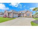 Beautiful brick home featuring a well manicured lawn and an attached garage at 169 Kessinger Dr., Surfside Beach, SC 29575