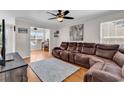 Spacious living room with a large brown sectional sofa, hardwood floors, and ample natural light at 2629 Scarecrow Way, Myrtle Beach, SC 29579