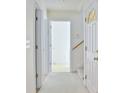 Bright hallway with white doors and trim and soft carpet leading to the upper level at 319 16Th Ave. S, Surfside Beach, SC 29575