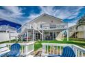 The backyard features white fencing, green grass, and a patio beneath the deck at 325 52Nd Ave. N, North Myrtle Beach, SC 29582