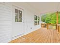 Covered deck with white siding and wood railings, overlooking trees at 3566 Steamer Trace Rd., Conway, SC 29527