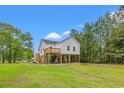 Exterior elevation of elevated coastal home on a grassy lot at 3566 Steamer Trace Rd., Conway, SC 29527