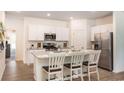 Modern kitchen featuring stainless steel appliances, granite countertops and an island with seating at 362 Ladyfish Loop, Sunset Beach, NC 28468