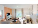 Inviting living room with large windows, plush seating, and stylish decor at 362 Ladyfish Loop, Sunset Beach, NC 28468