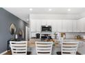 Stylish kitchen featuring granite countertops, white cabinets, and stainless steel appliances at 366 Ladyfish Loop, Sunset Beach, NC 28468