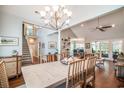 Bright dining area with a chandelier, stairs to the second story and hardwood floors at 38 Saint Annes Pl., Pawleys Island, SC 29585