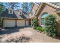 Spacious three-car garage with a brick driveway and well-maintained landscaping at 38 Saint Annes Pl., Pawleys Island, SC 29585