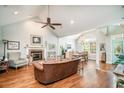 Open concept living room featuring a fireplace, vaulted ceilings and hardwood floors at 38 Saint Annes Pl., Pawleys Island, SC 29585