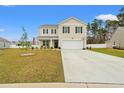Inviting two-story home with a well-manicured lawn and spacious driveway at 380 Harvest Ridge Way, Conway, SC 29527