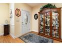 Inviting entryway with wood floors, decorative cabinet, area rug and glass-paneled door at 951 Foxtail Dr., Longs, SC 29568