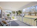 Relaxing front porch featuring rocking chairs and an open view of the surrounding neighborhood at 107 Ben Horry Trail, Pawleys Island, SC 29585